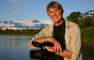 Photograph of Boyd Matson in front of lake and holding a camera